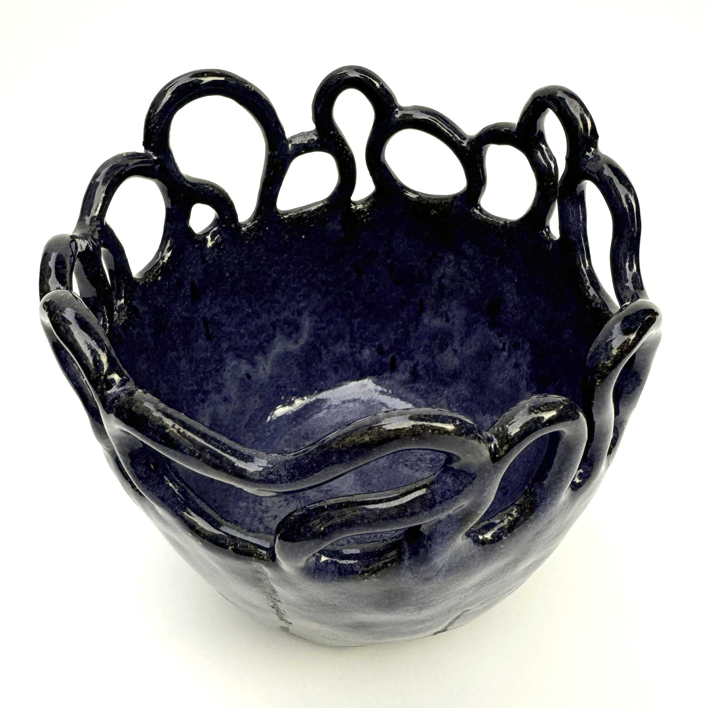 The rim of the main part of bowl is a bit wavy and connects into the coils in a flowing way.