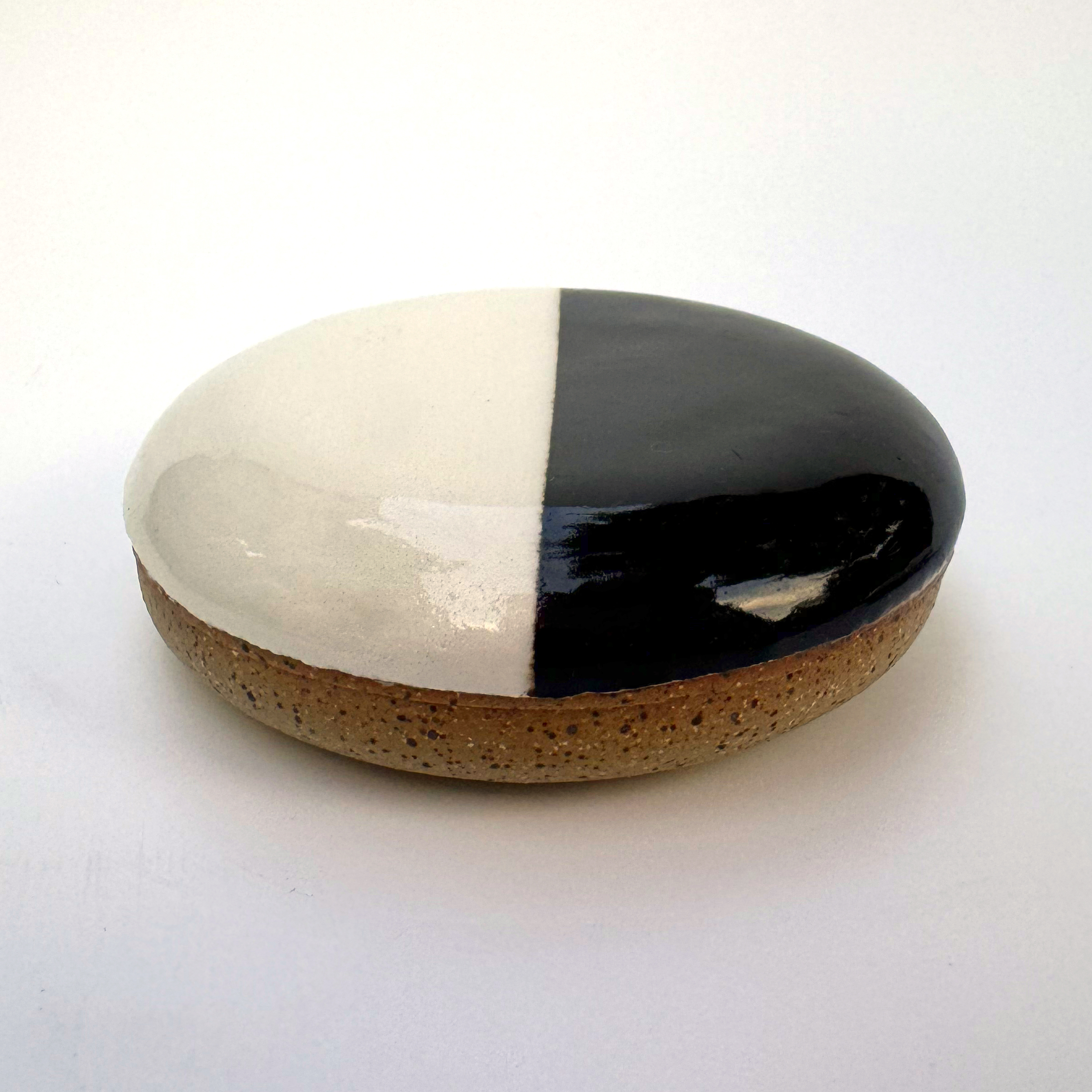 A light tan clay with speckles represents the cake part of the black and white cookie.