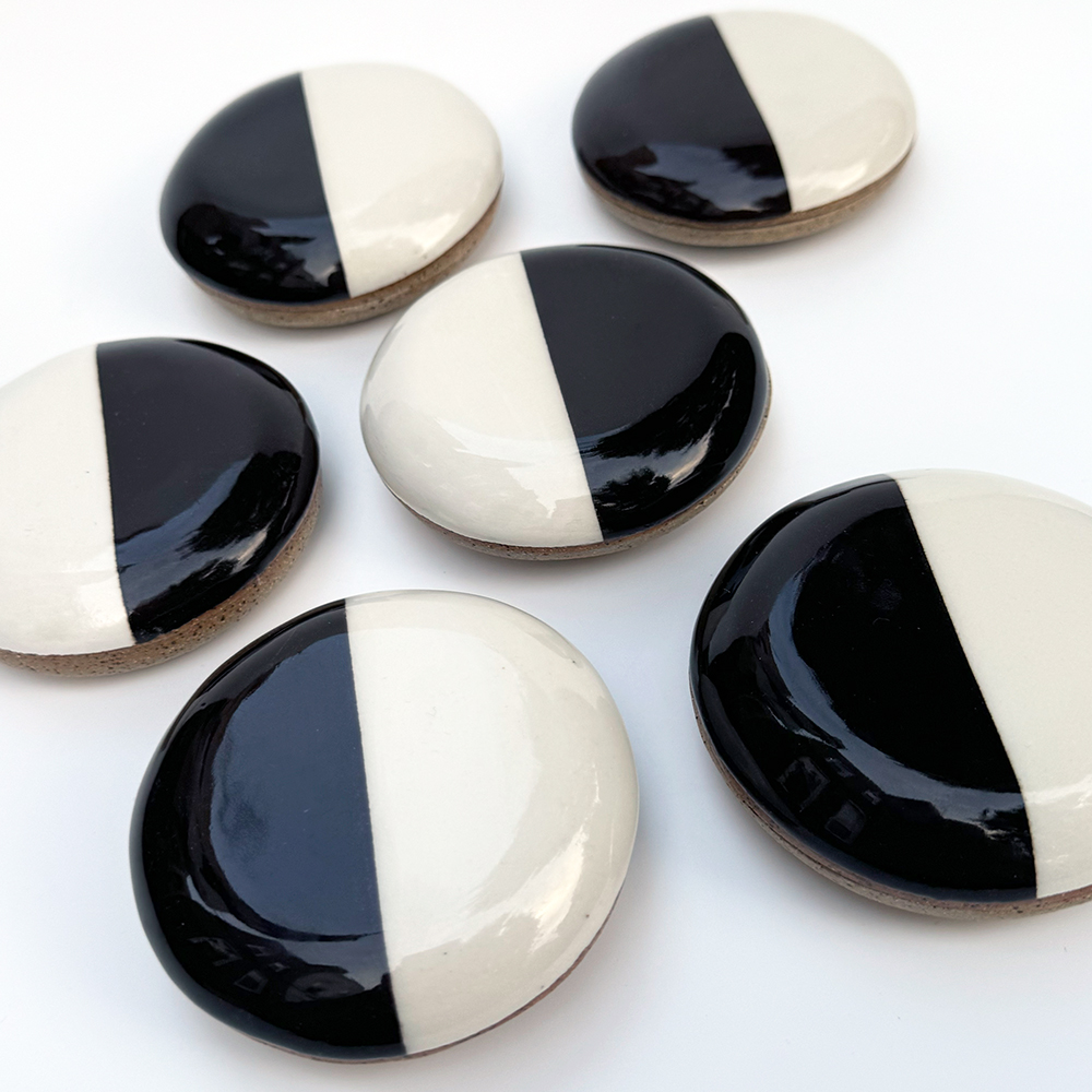 A bunch of black and white cookies are actually shallow pill jars.