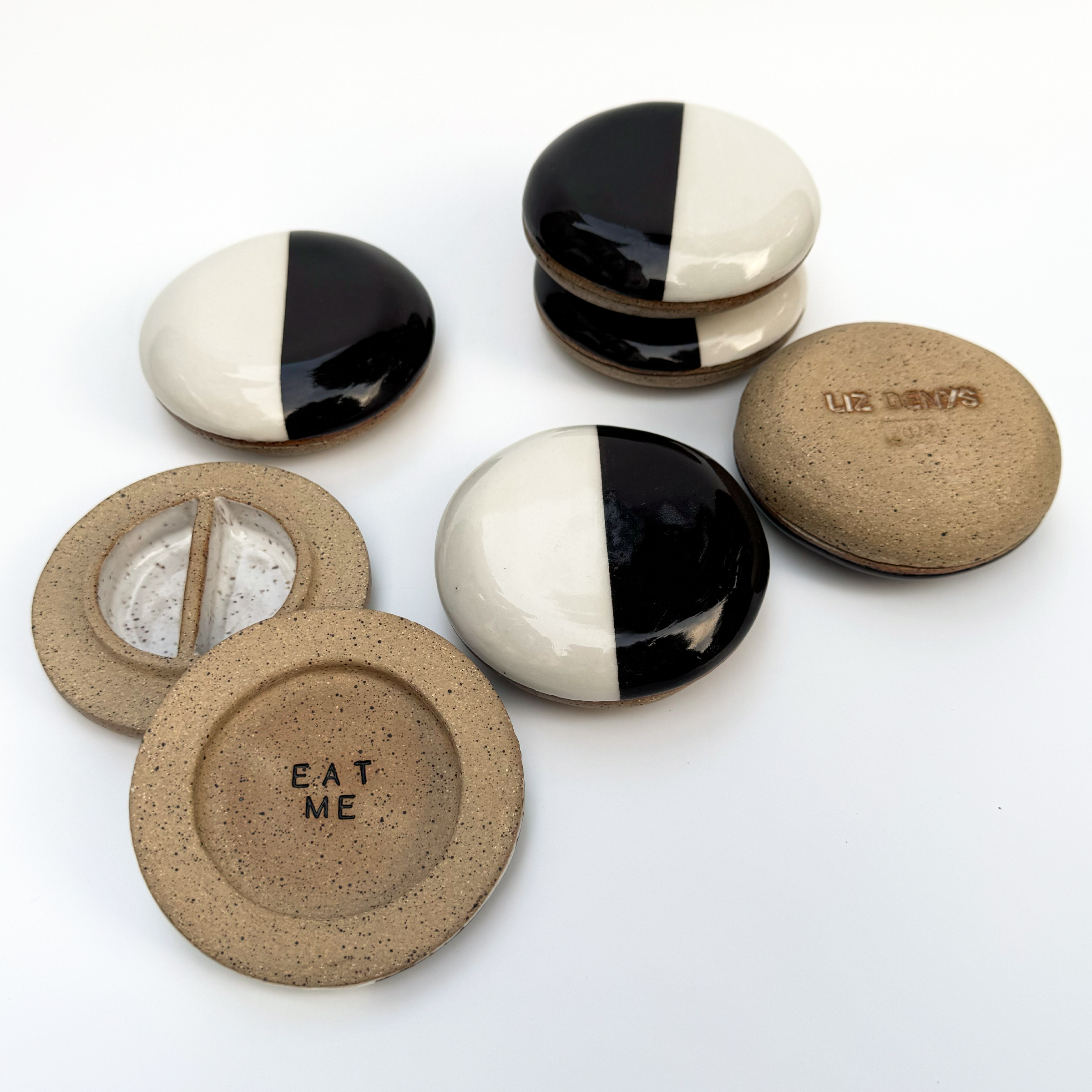 These shallow pill jars are made to look like ceramic black and white cookies.