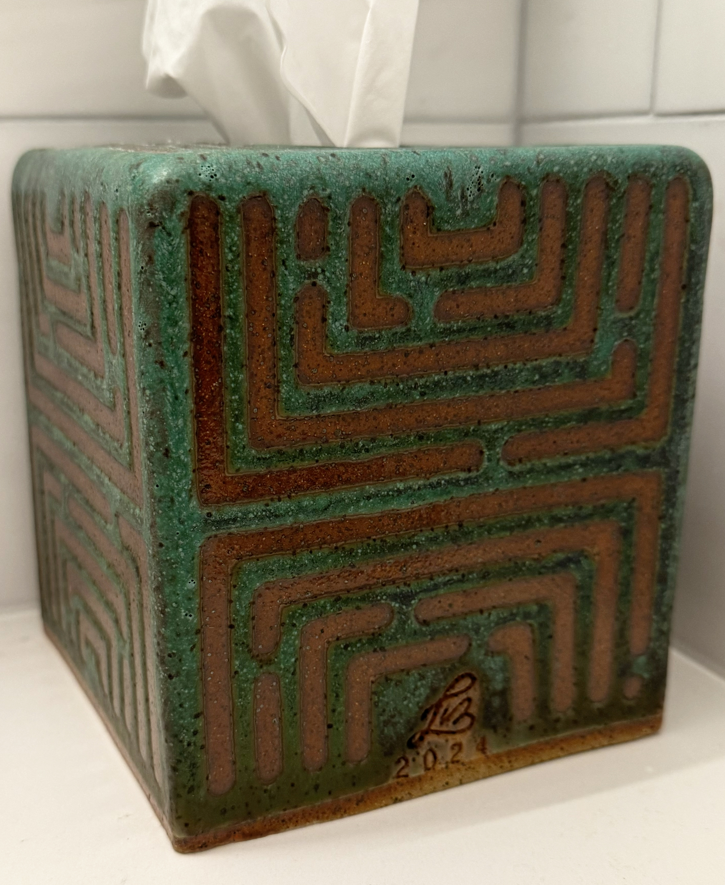 Each side of the tissue box has a unique maze-like pattern.