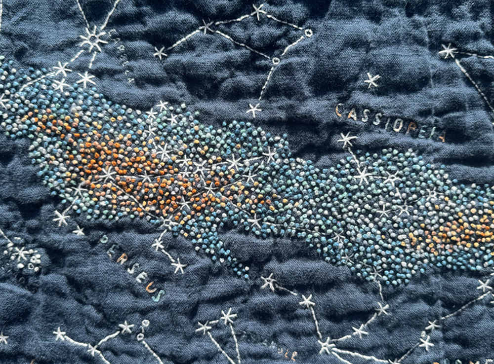 Close-up of Perseus and Cassiopeia. Their stars and constellation visualizations in white are tucked tightly within the French knots of the Milky Way.