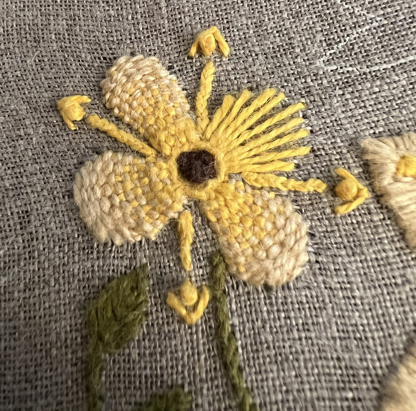 The same type of woven flower, but with a yellow warp instead of the red orange.