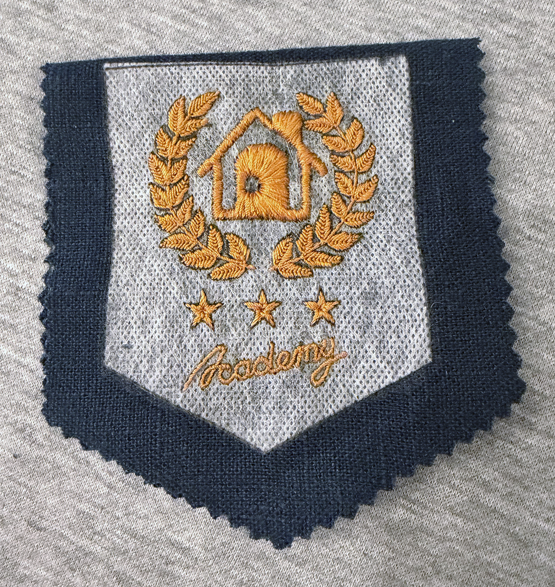 With the embroidery complete but the Sulky Fabri-Solvy template not yet washed off, I carefully cut out the mini-pennant out using pinking shears and giving it a 1/2-inch seam allowance. This is what it looks like folded over before sewing the edge seams.