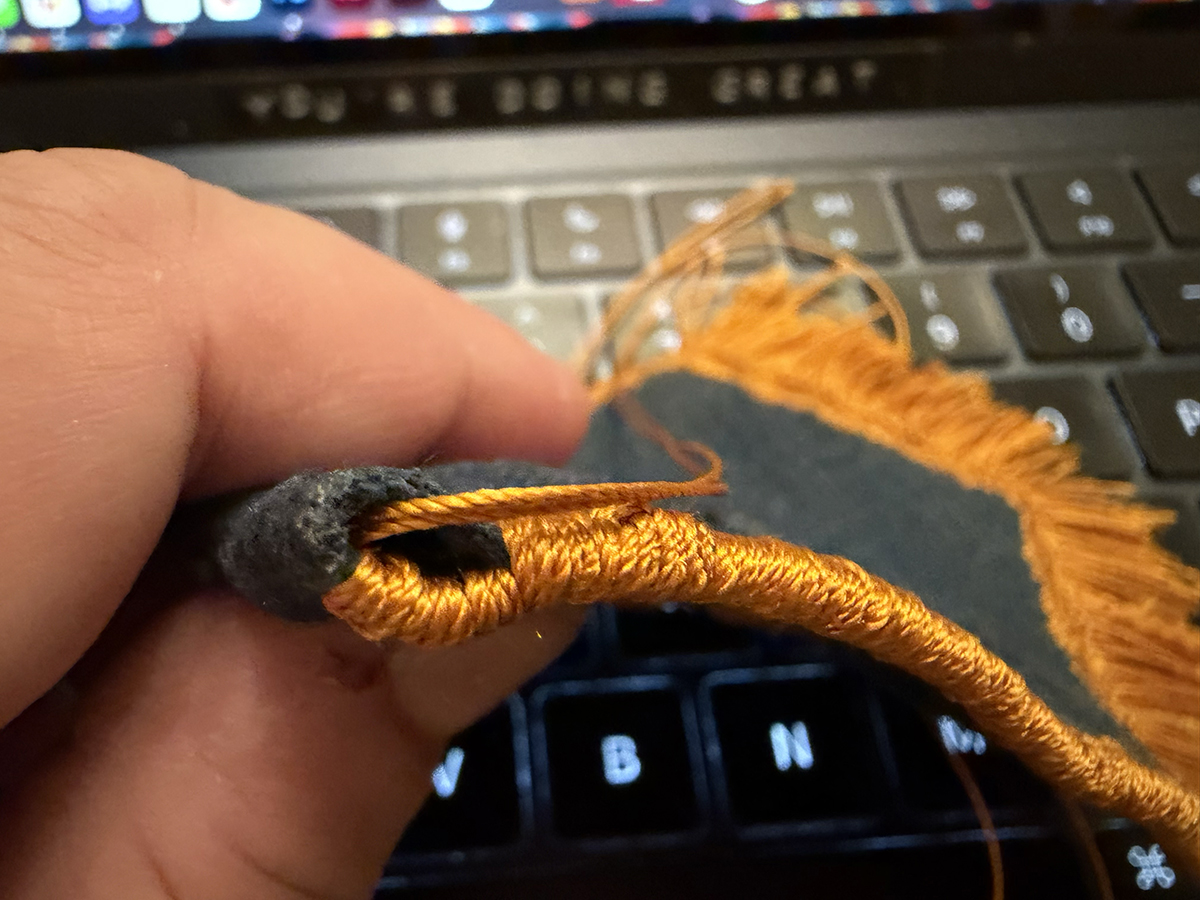 The edge wrap finishing even goes around the section where the dowel is inserted at the top, but of course, it only goes around one of the two sides of the pennant to form a opening to insert the rod.