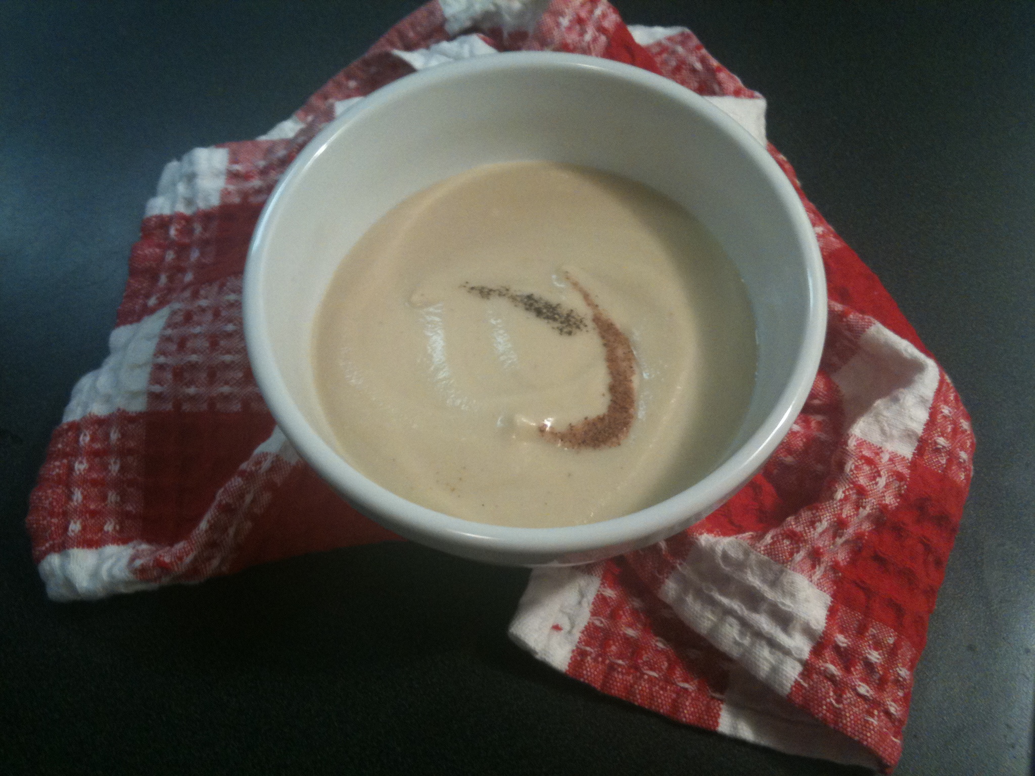Creamy Vidalia onion soup topped with nutmeg and pepper