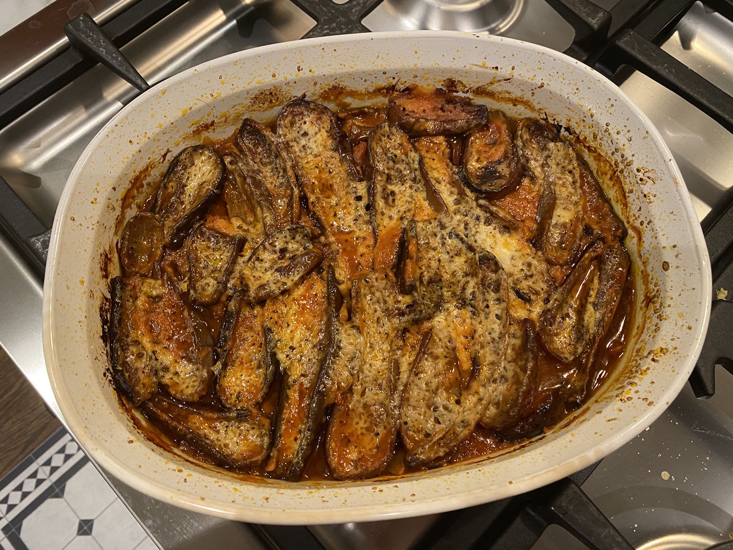 Photo of a casserole dish full of eggplant parmigiana on top of my stove