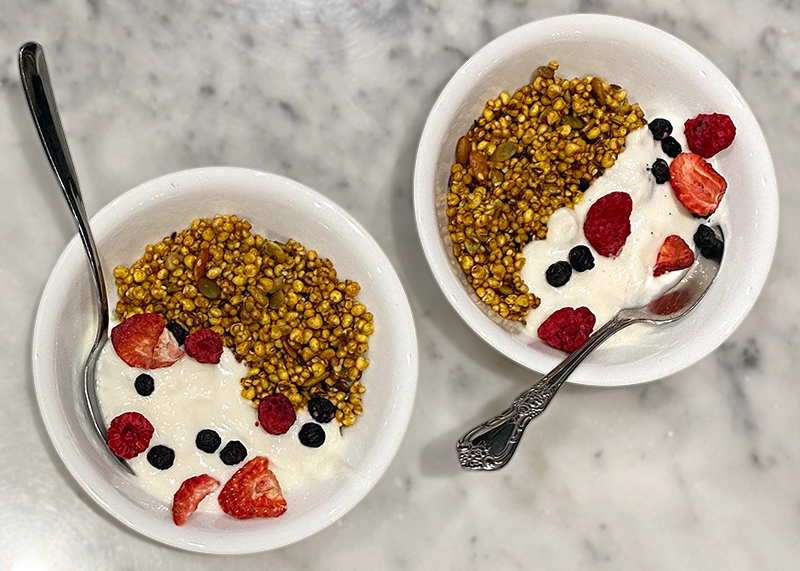 Two bowls of puffed millet and qui'nola with yogurt