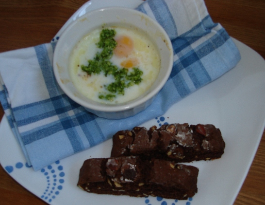 Shirred eggs with pesto sauce, spiced chocolate biscotti
