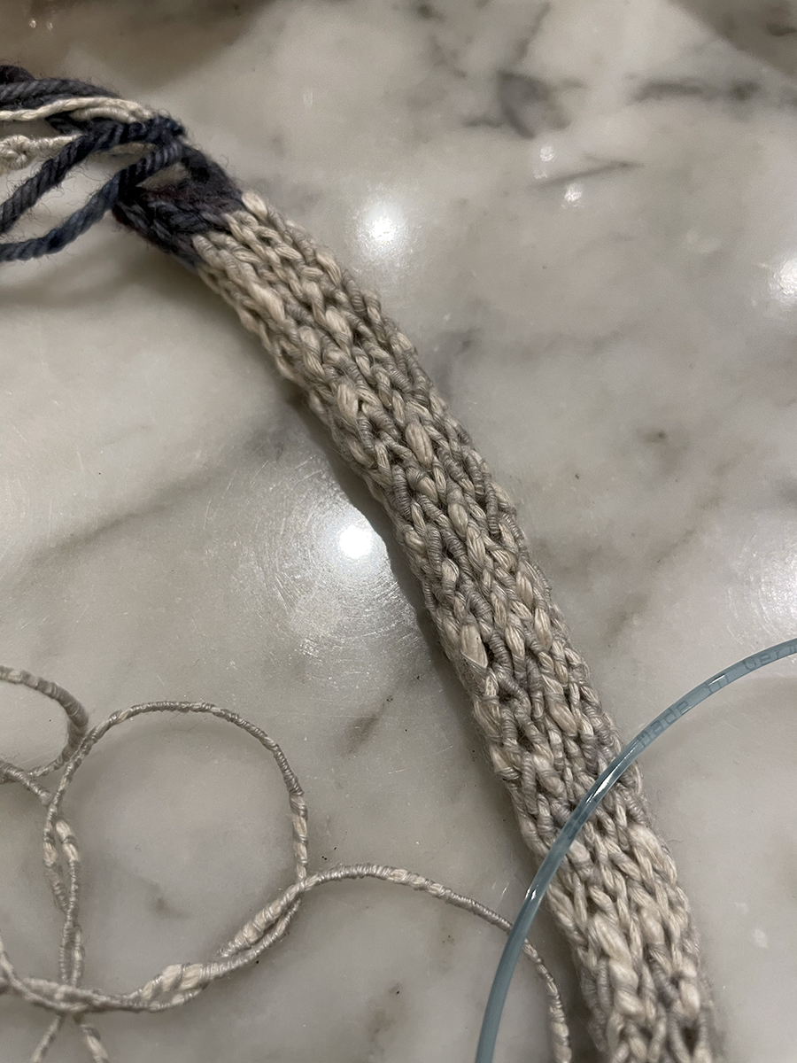 The curtain ties begin with a provisional cast on - I used some denim blue wool scrap yarn.