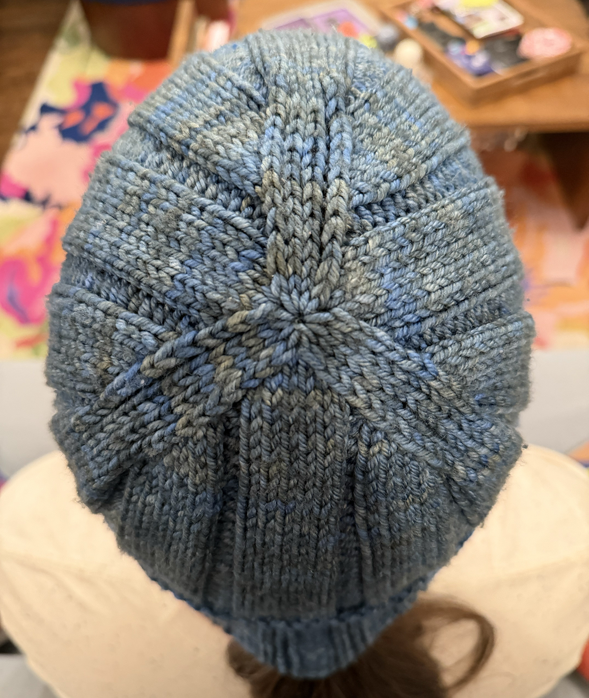 Three 4-stitch wide knit sections continue all the way to the center of the top of the hat, forming a subtle 3-pointed star.