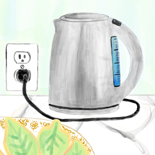 Tea kettle plugged into a wall outlet and a plate of frosted leaf cookies